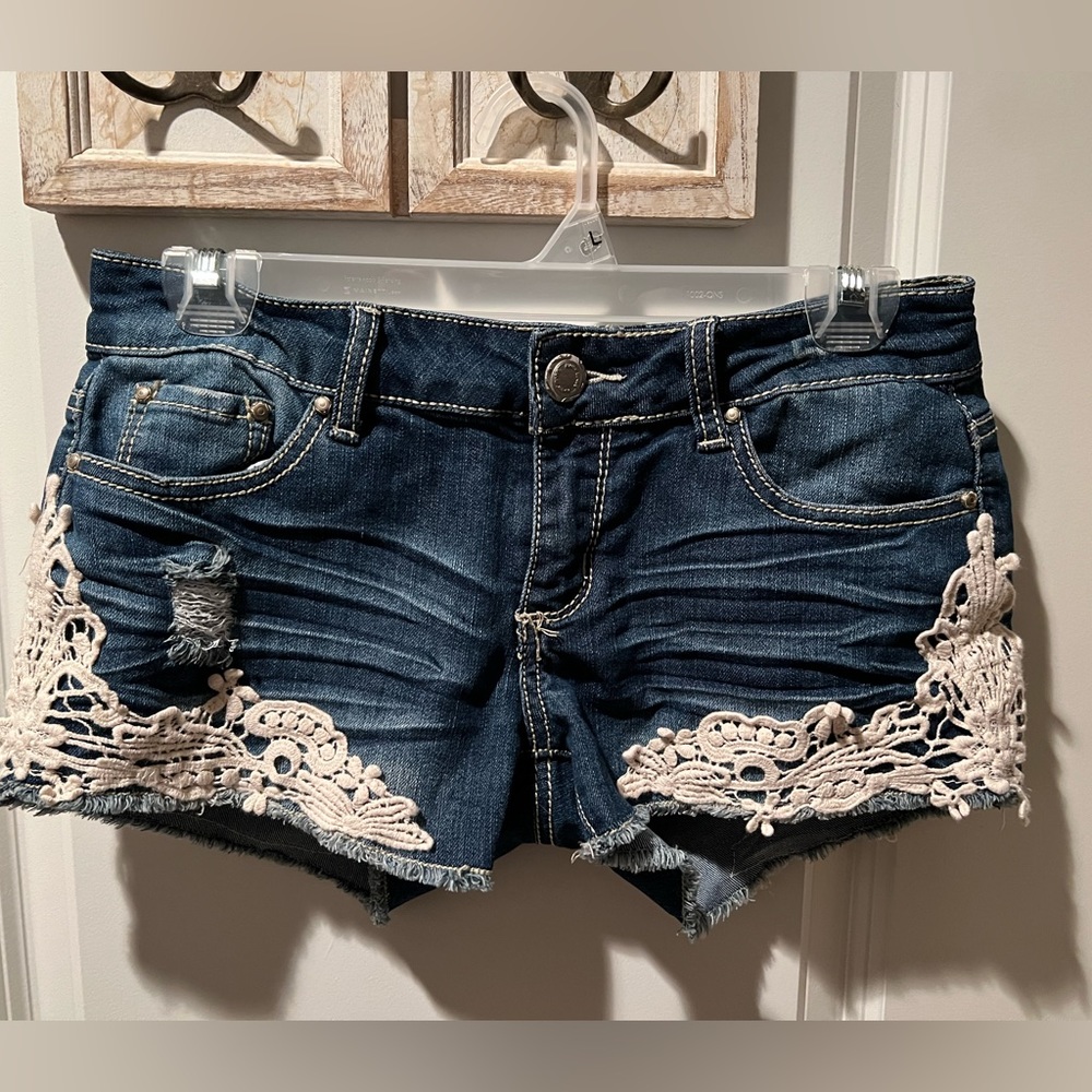 Almost Famous jean shorts with lace on the legs.